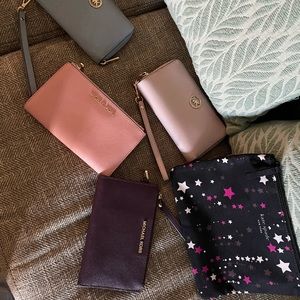 4 michael kors wristlets and 1 kate spade pouch!